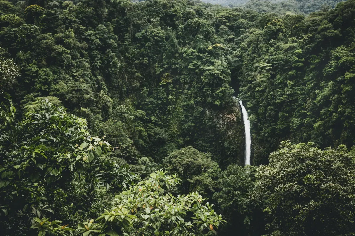 La Fortuna waterfall dropping into a green pool near La Fortuna, Costa Rica